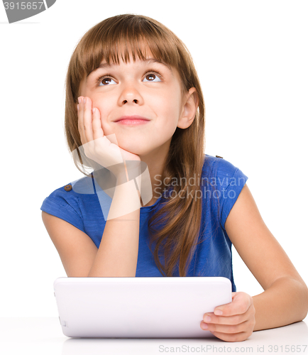 Image of Young girl is using tablet