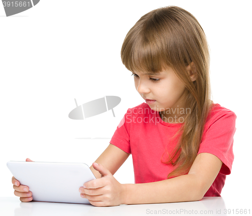 Image of Young girl is using tablet