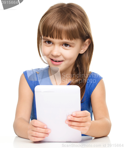Image of Young cheerful girl is using tablet