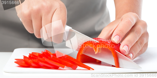 Image of Cook is chopping bell pepper