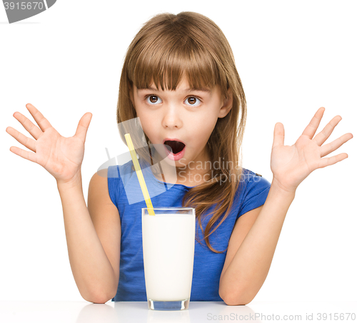 Image of Cute little girl with a glass of milk