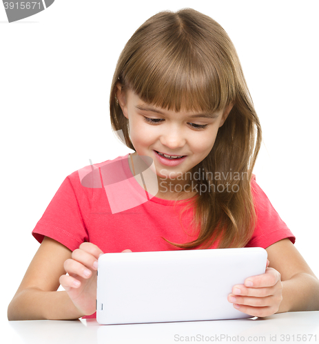 Image of Young girl is using tablet