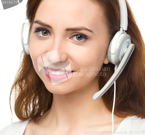Image of Lovely young woman is talking to customers