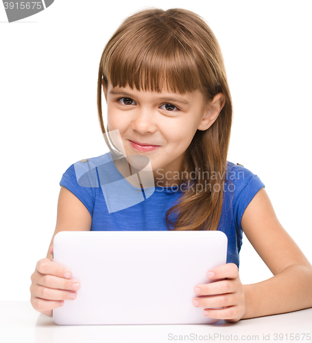 Image of Young girl is using tablet