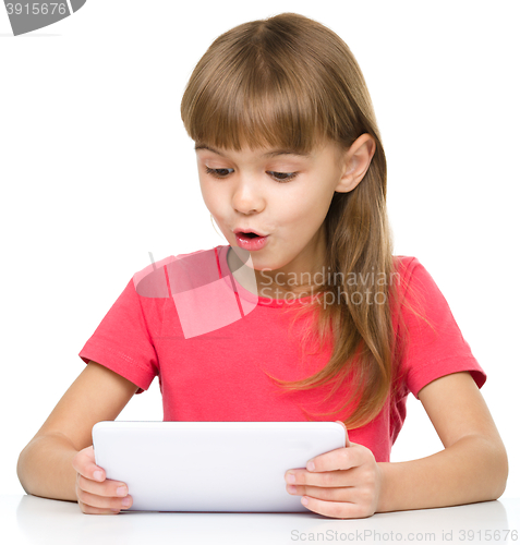 Image of Young girl is using tablet