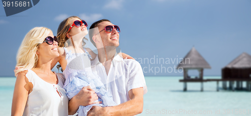 Image of happy family over tropical beach with bungalow