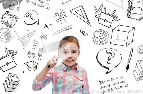 Image of happy little girl looking through magnifying glass