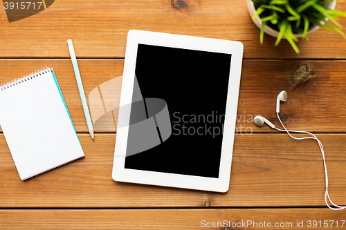 Image of close up of tablet pc computer on wooden table