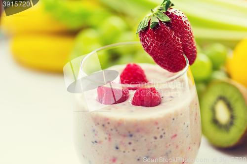 Image of close up of glass with milk shake and fruits