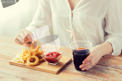 Image of close up of woman with snacks and cola