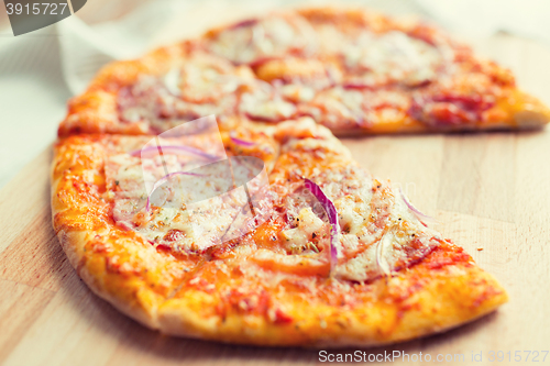 Image of close up of homemade pizza on wooden table