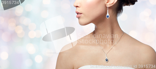 Image of close up of woman with earring and pendant