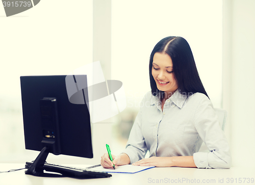 Image of smiling businesswoman or student studying