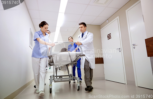 Image of medics and patient on hospital gurney at emergency