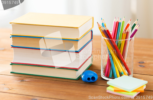 Image of close up of crayons or color pencils and books