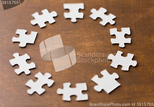 Image of close up of puzzle pieces on wooden surface