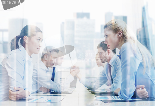 Image of smiling business people having conflict in office