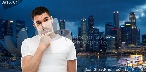 Image of man thinking over gray background