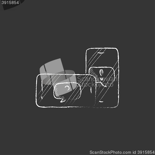 Image of Two smartphones with speech squares on screen. Drawn in chalk icon.