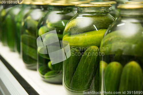 Image of gurtsov conservation. Fresh cucumbers in jars