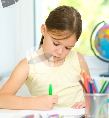 Image of Cute cheerful child drawing using felt-tip pen
