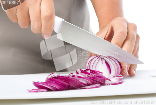 Image of Cook is chopping onion