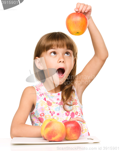 Image of Little girl with apples is showing thumb up sign