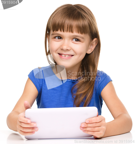 Image of Young girl is using tablet