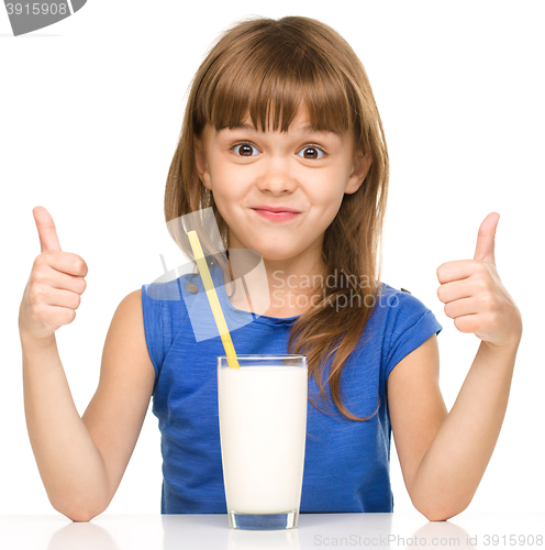 Image of Cute little girl with a glass of milk