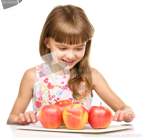 Image of Little girl with red apples