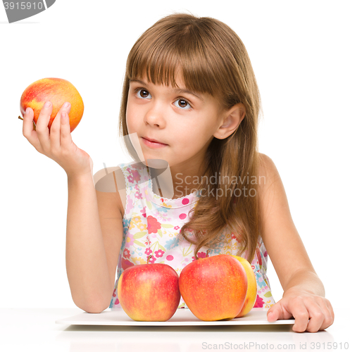 Image of Little girl with red apples