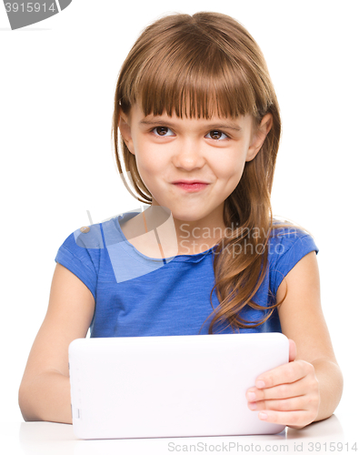 Image of Young cheerful girl is using tablet
