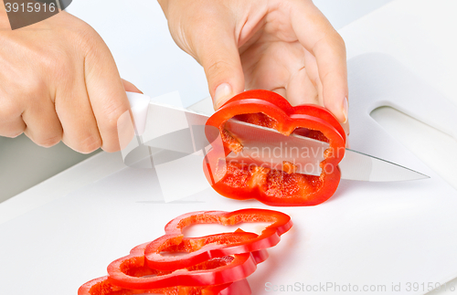 Image of Cook is chopping bell pepper