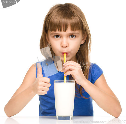 Image of Cute little girl with a glass of milk