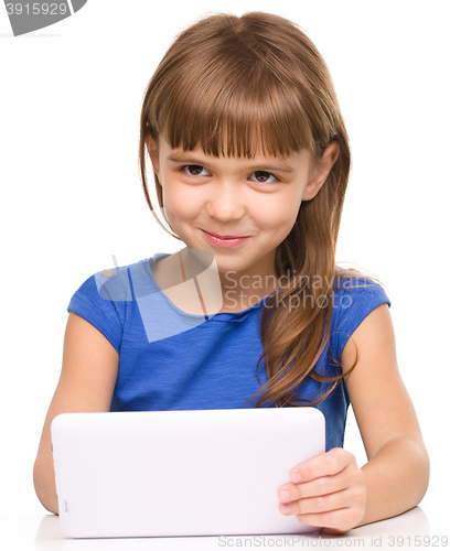 Image of Young girl is using tablet