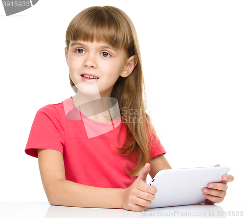 Image of Young girl is using tablet