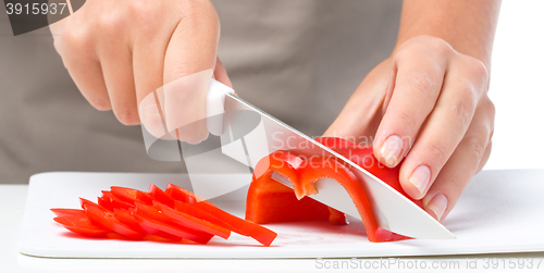 Image of Cook is chopping bell pepper