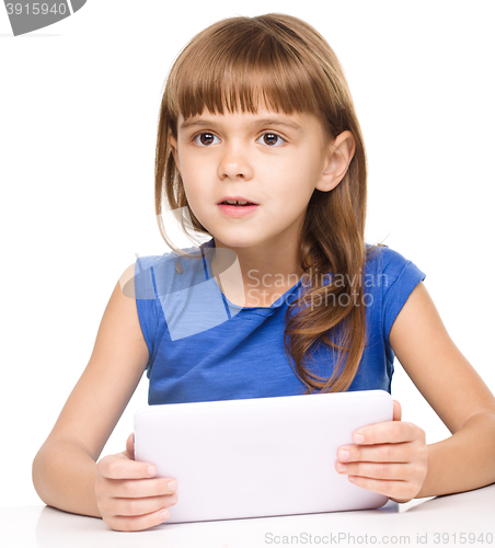 Image of Young girl is using tablet
