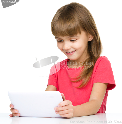 Image of Young girl is using tablet
