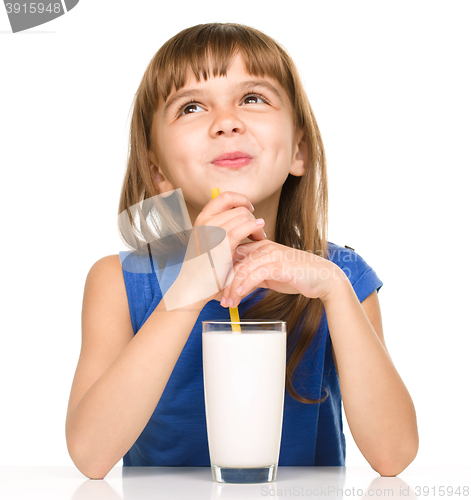 Image of Cute little girl with a glass of milk