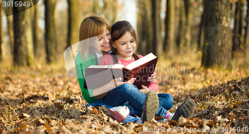 Image of Mother is reading book with her daughter