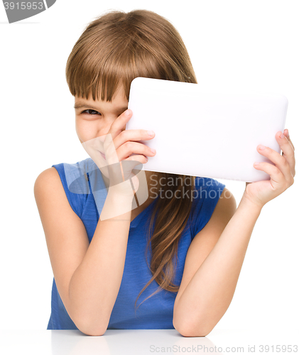 Image of Young cheerful girl is using tablet