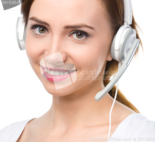 Image of Lovely young woman is talking to customers