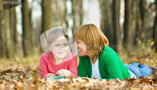 Image of Mother is reading book with her daughter