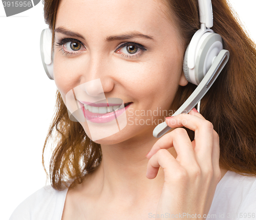 Image of Lovely young woman is talking to customers
