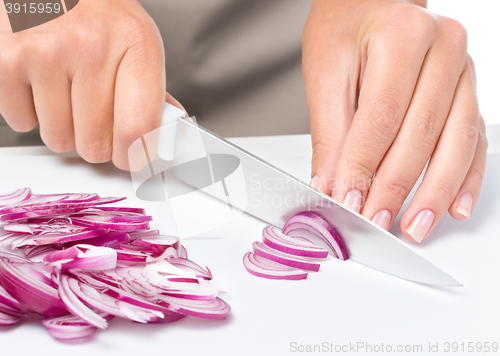 Image of Cook is chopping onion