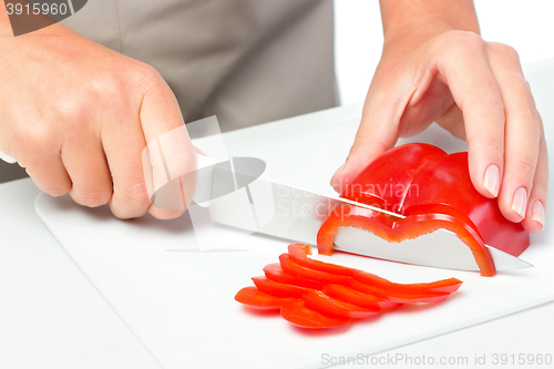 Image of Cook is chopping bell pepper