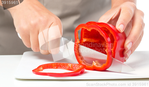 Image of Cook is chopping bell pepper