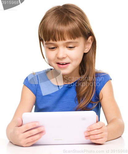 Image of Young girl is using tablet
