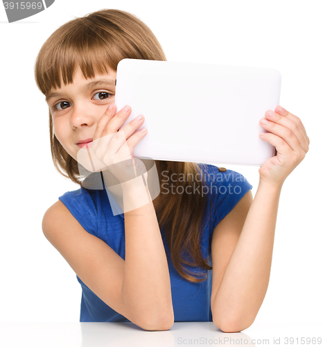 Image of Young cheerful girl is using tablet